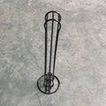 Black wrought iron coffee capsule storage rack holding 20 pods on a kitchen counter.