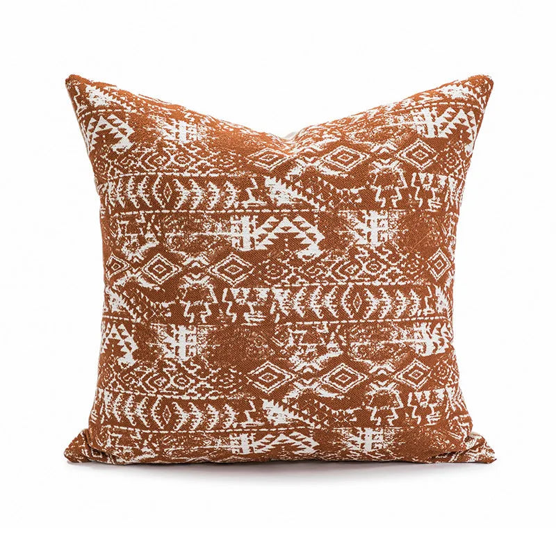 A square solid-colour cushion pillow on a sofa, showing its plain edge detail.