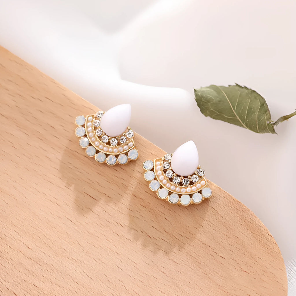 A pair of women's silver retro fan-shaped earrings with rhinestone and opal-like geometric details.