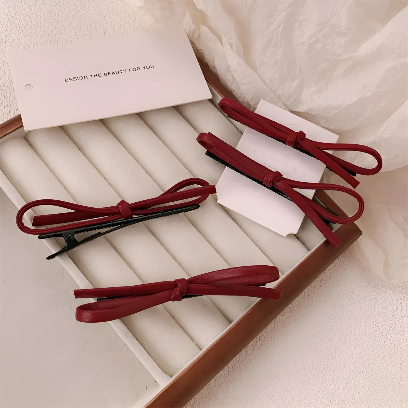 Handmade wine red leather bow barrette on a metal hair clip, showing the 5.5cm wide bow shape.