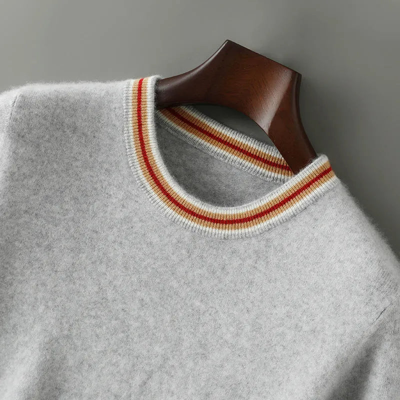 A man's short sleeve grey wool jumper with a round neckline on a hanger.