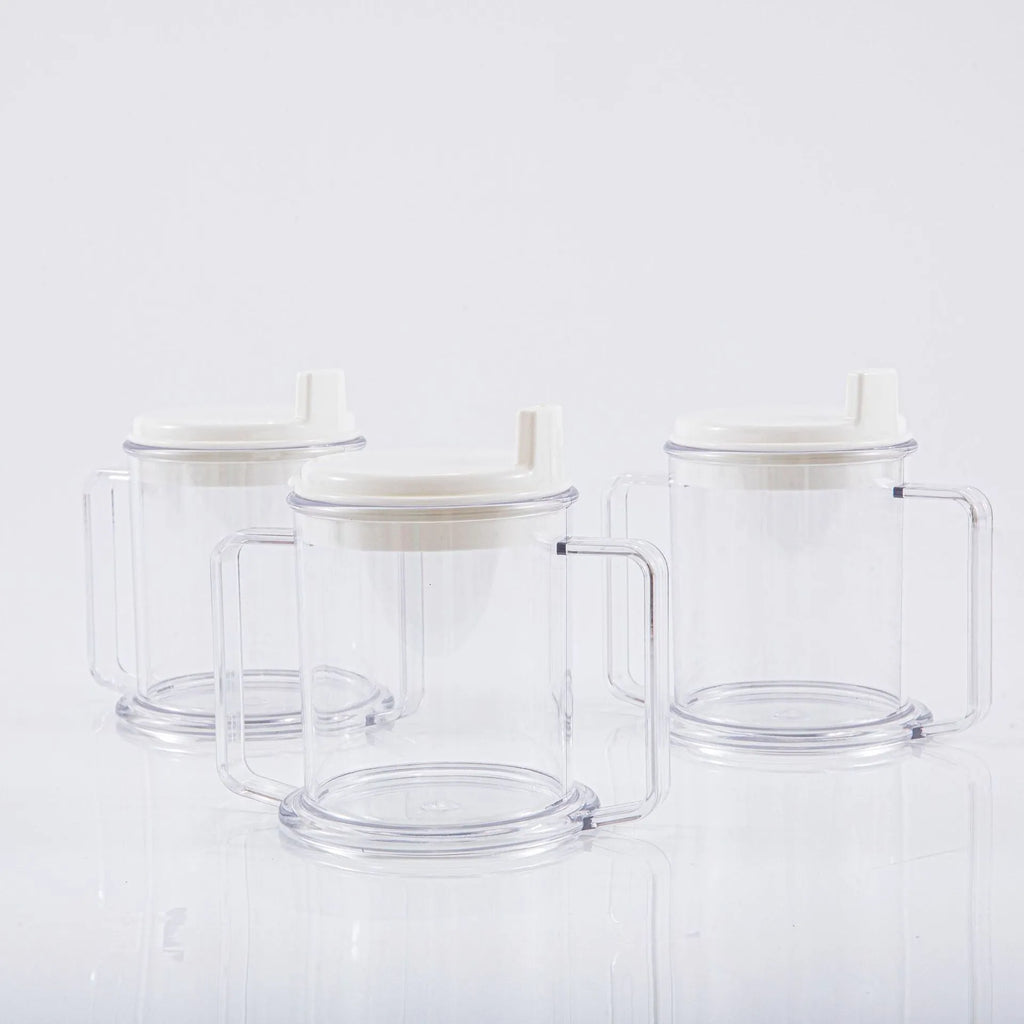 Transparent spill-proof drinking cup with solid colour, 14cm height, on table