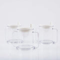 Transparent spill-proof drinking cup with solid colour, 14cm height, on table