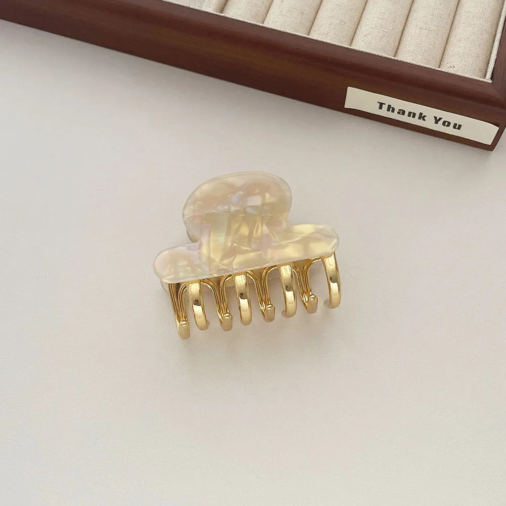 A medium-sized retro acetate hair barrette with a metal grip in a choice of four colours.