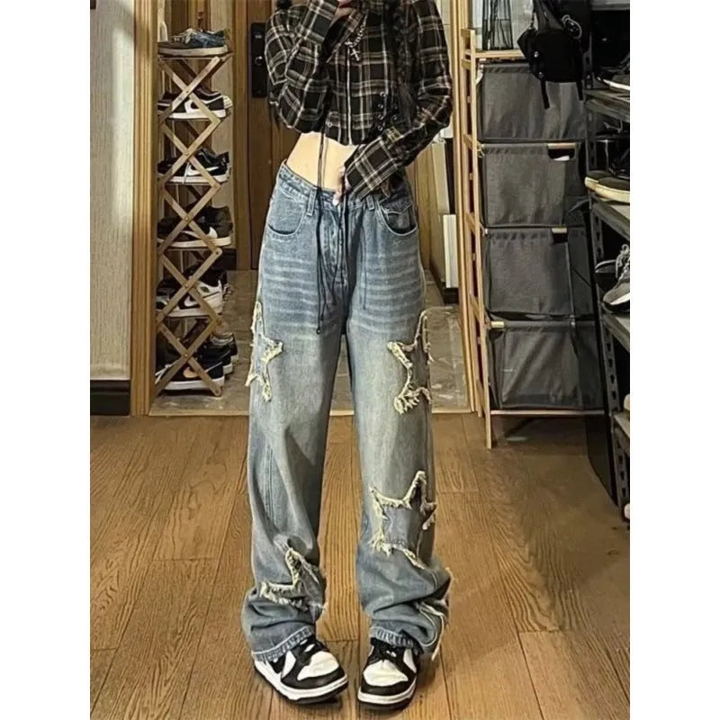 Women's blue high-waisted straight-leg jeans laid flat on a surface.