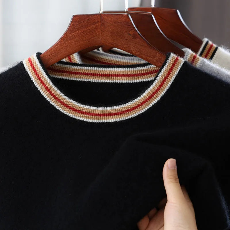 A man's short sleeve grey wool jumper with a round neckline on a hanger.