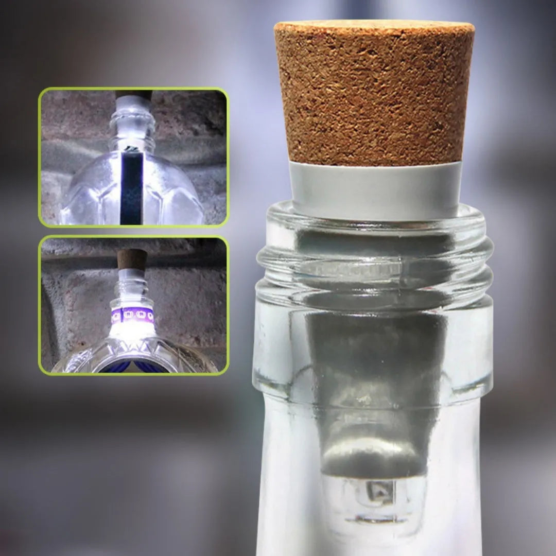 White plastic USB-rechargeable LED bottle cap cork light with micro-USB port, shown next to a whisky bottle.