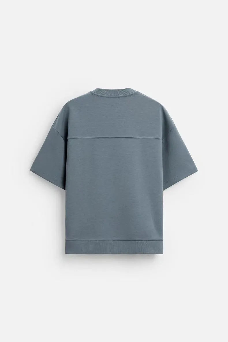 Loose fit short sleeve casual top with double-sided texture in blue, shown with a round collar.