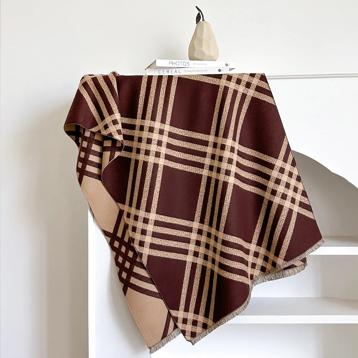Mid-length brown imitation cashmere winter scarf with tassel trim laid flat.