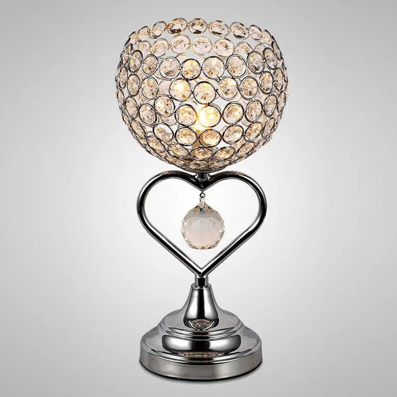 Modern minimalist crystal USB table lamp with heart-shaped design on a bedside table