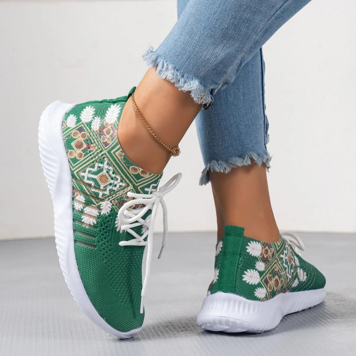 Women's woven flat casual sneakers in green with mesh upper, round toe, front lace-up, and rubber sole