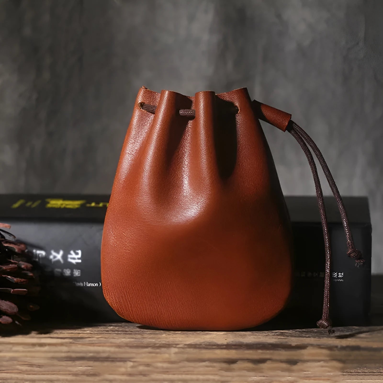 Vintage cowhide leather drawstring pouch wallet in black shown open and closed