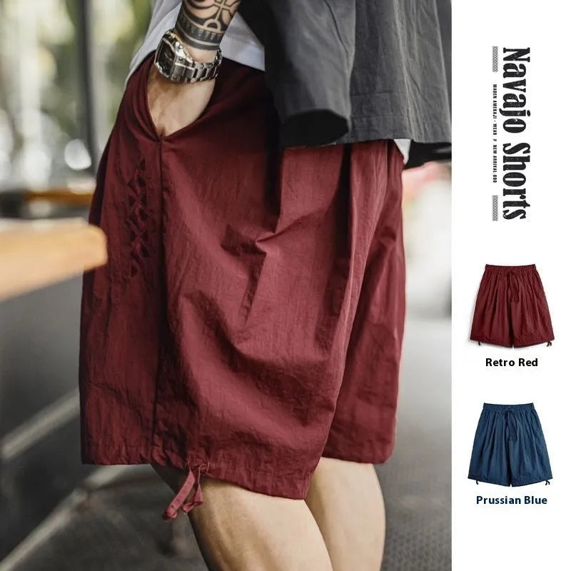 Men's embroidered loose fit nylon shorts in Prussian Blue colour with elastic waistband
