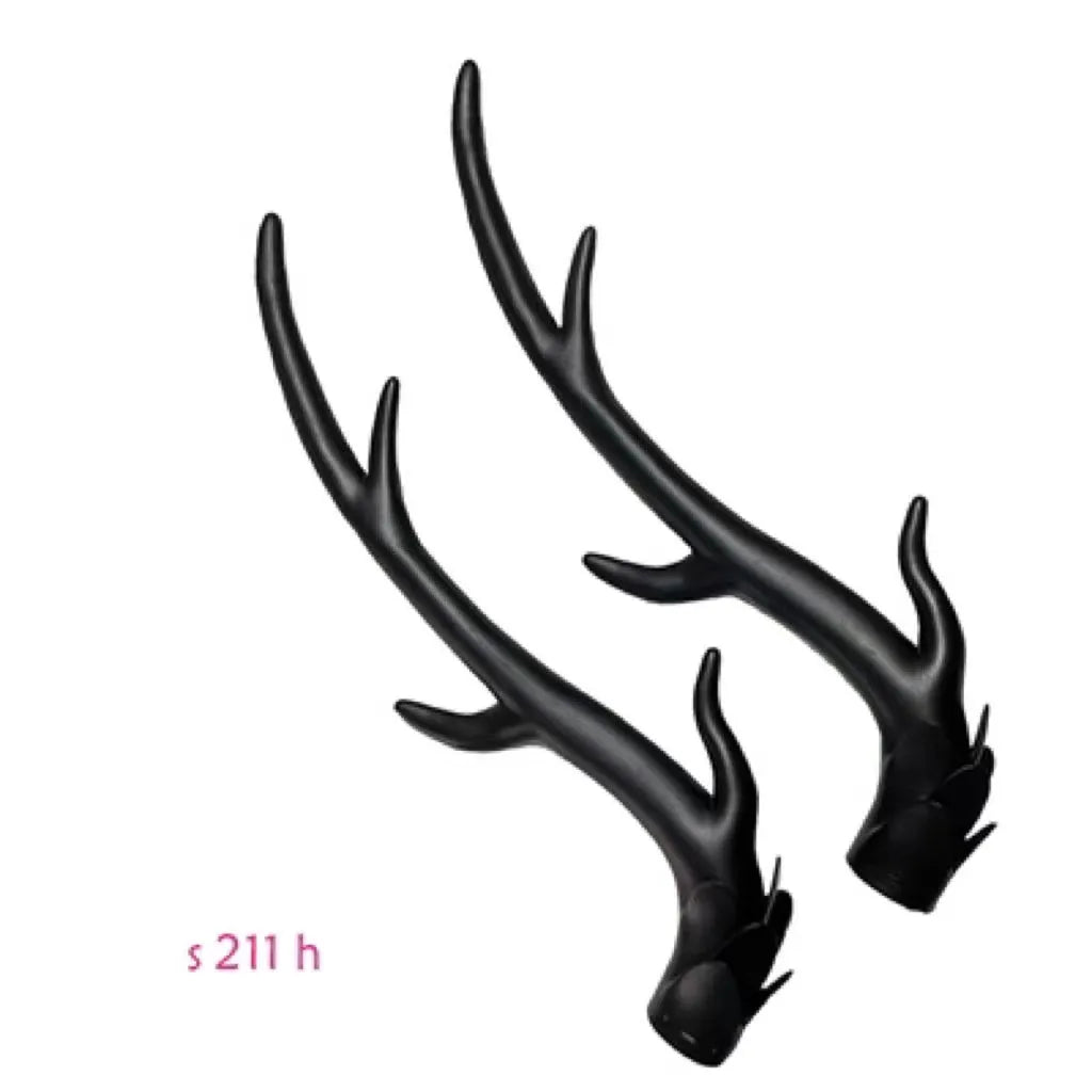 A pair of black resin dragon horn decorations for motorcycle helmets, showing curved shape and textured surface.