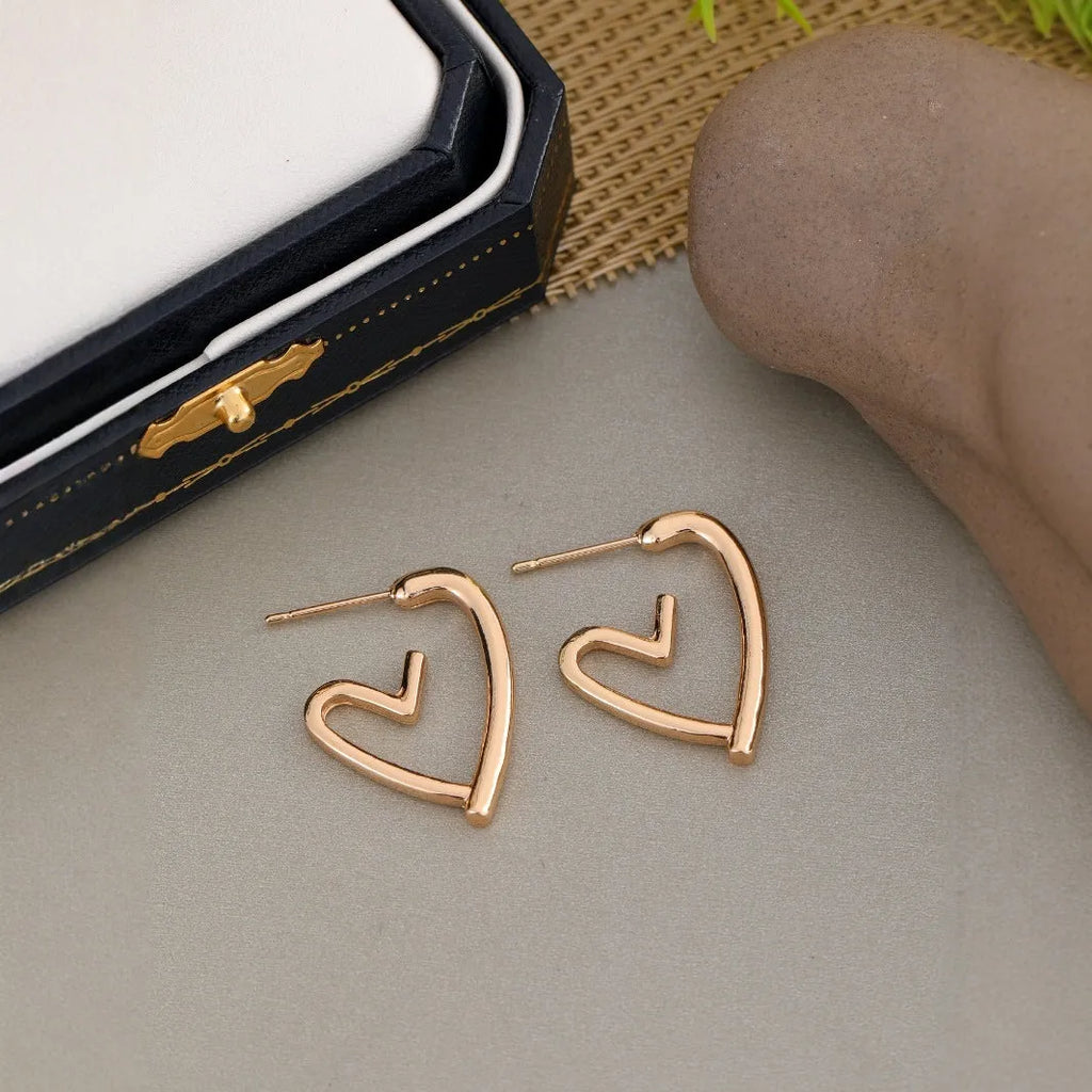 Simple cold style love earrings for women in golden colour metal alloy finish