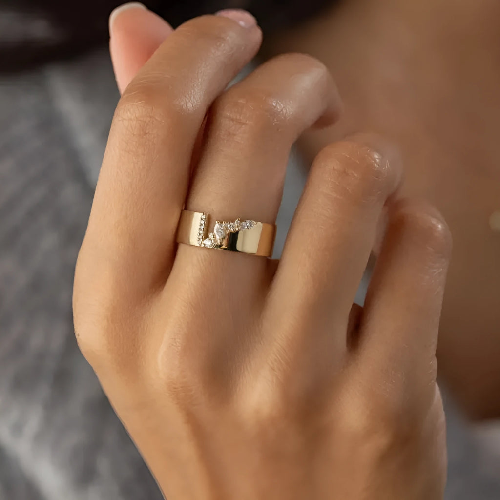 Gold-coloured women's ring with shining zircon stones on a copper band.