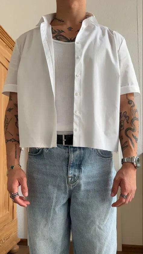 White men's cropped top short sleeve polyester shirt on a hanger.