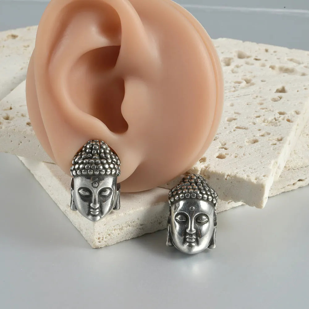 Stainless steel hollow skull and Buddha geometric design earrings in hip hop style.