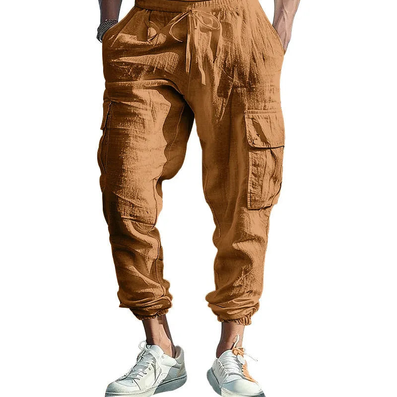 Men's solid colour linen trousers with ankle-tied cuffs, drawstring waist, and multiple pockets.