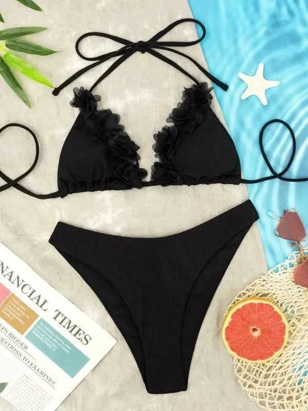 Black polyester swimwear two-piece set with a gathered design, showing the top and matching shorts.