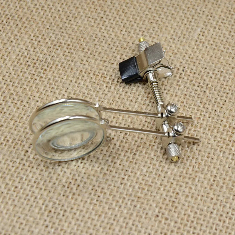 Auxiliary reading glass mirror double clip with metal bracket and glass lens.