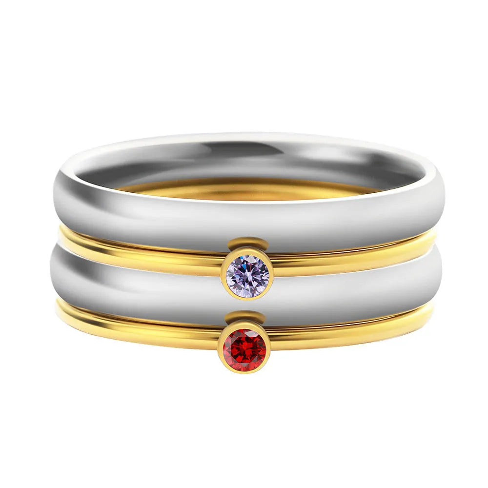 Geometric engraved titanium steel ring with December birthstone colours on a hand.