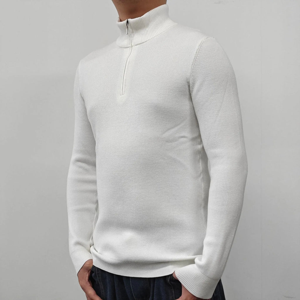 Man wearing a grey half-turtleneck zip-front sweater, a cotton blend pullover for casual wear.