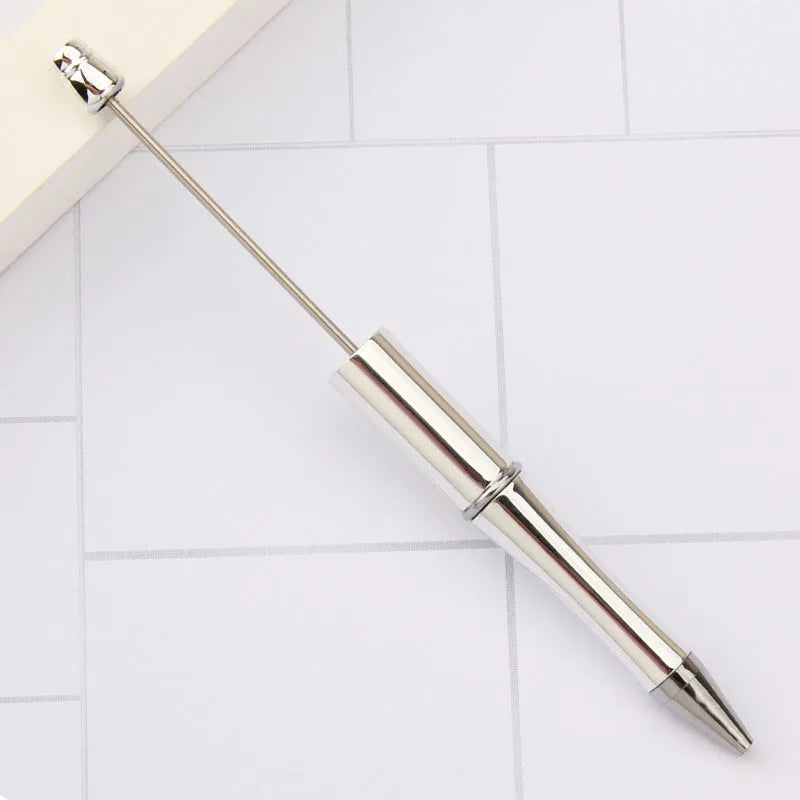 Colourful spinning ballpoint pen with plastic beads on a white background.