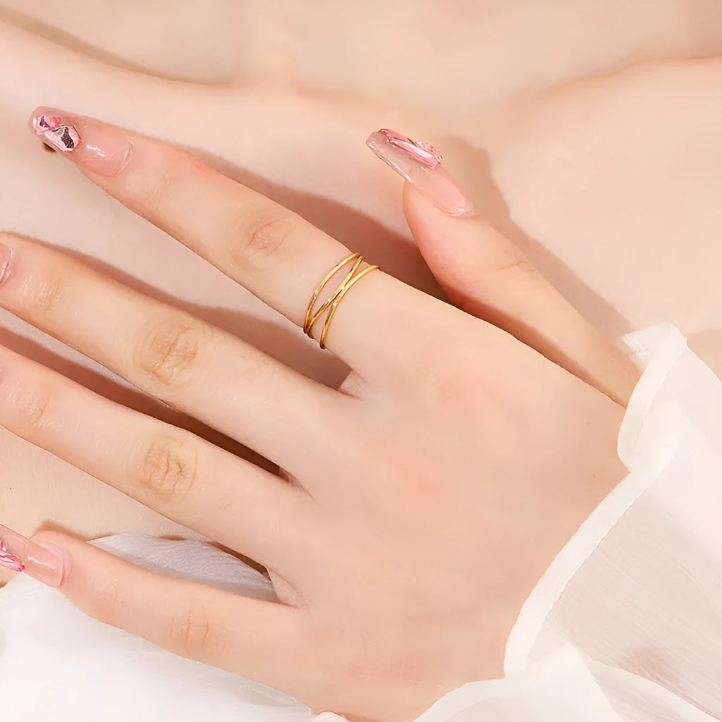 Gold-coloured titanium steel ring with a three-layer geometric coil band design.