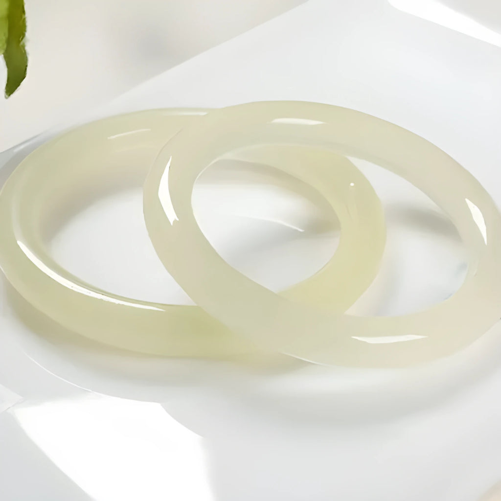 Natural ice silk jade round bar bracelet on a white background, showing its smooth texture and solid form.