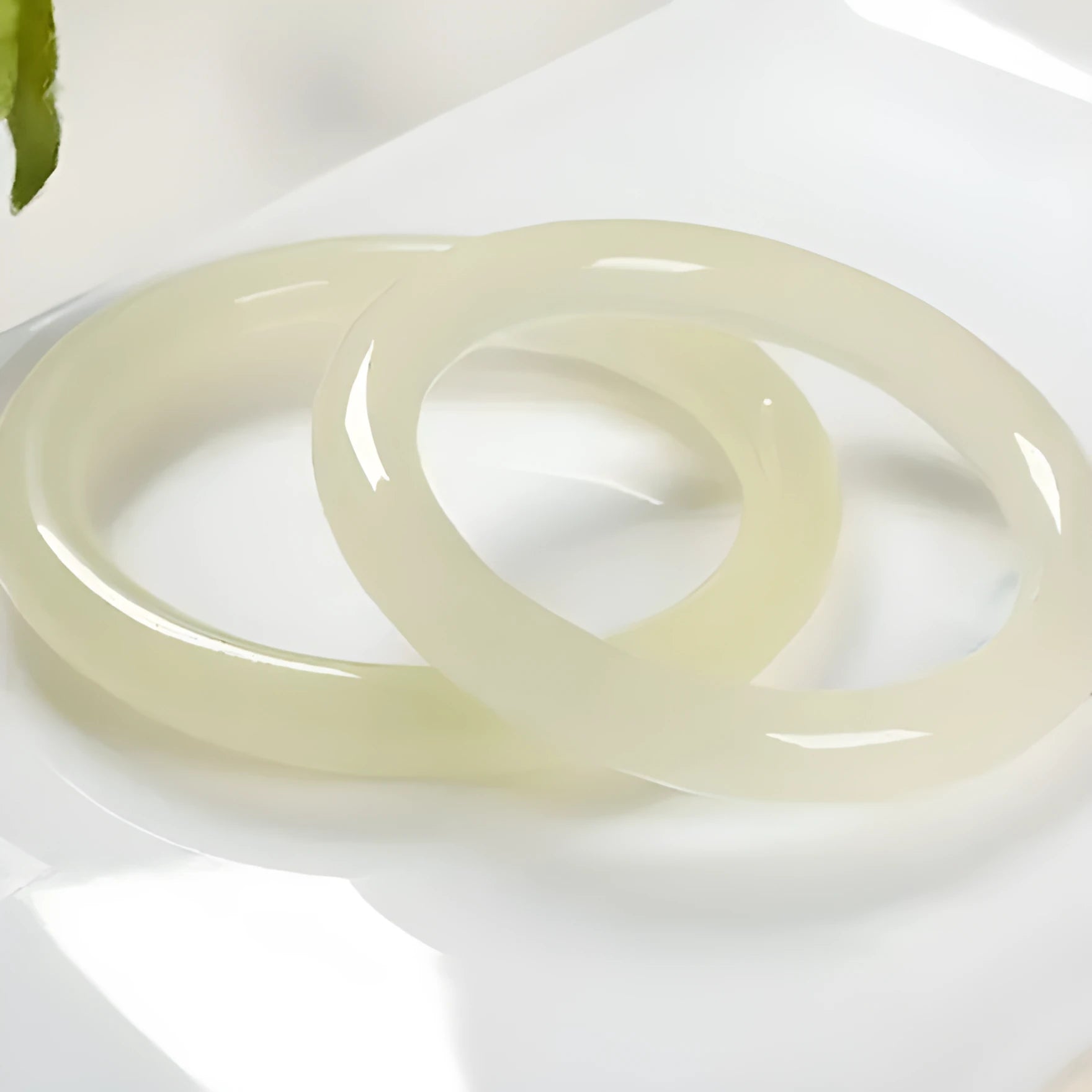 Natural ice silk jade round bar bracelet on a white background, showing its smooth texture and solid form.