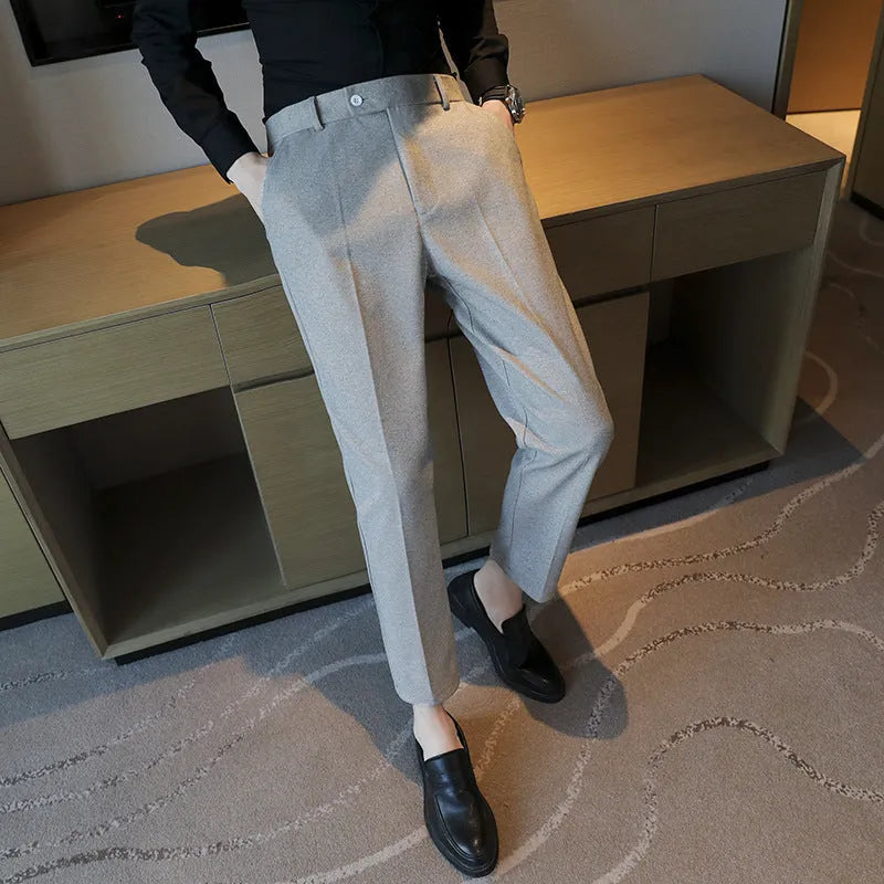 Straight-leg brown corduroy trousers with an elastic waistband laid flat.