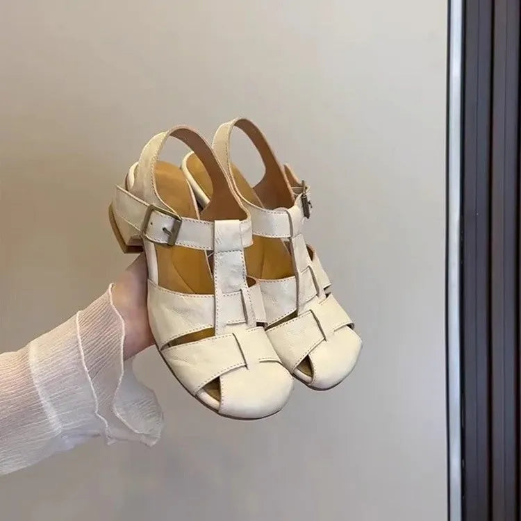 Women's Roman shoes in apricot colour with woven upper, buckle fastening, round toe, and low rubber sole