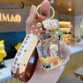 Oil-infused pearl milk tea bear acrylic alloy keychain pendant in mug style on a pink background