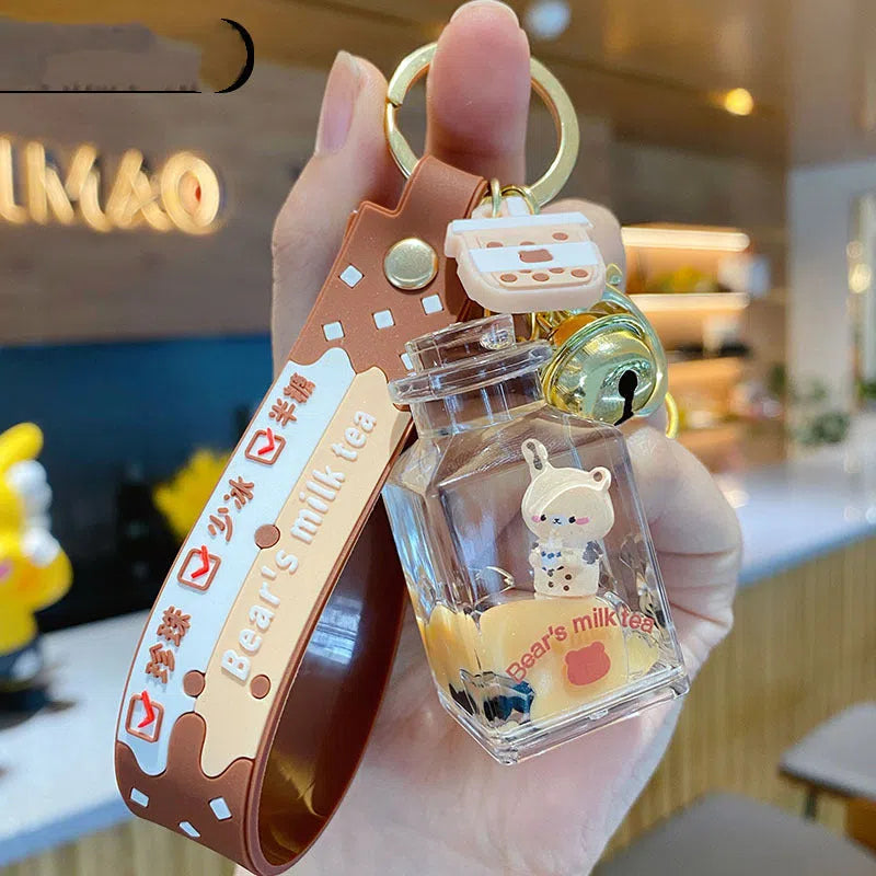 Oil-infused pearl milk tea bear acrylic alloy keychain pendant in mug style on a pink background