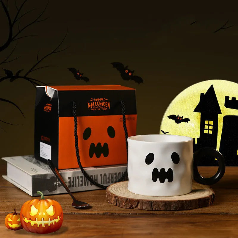 Orange ceramic pumpkin mug with handle on gift box with dessert spoon