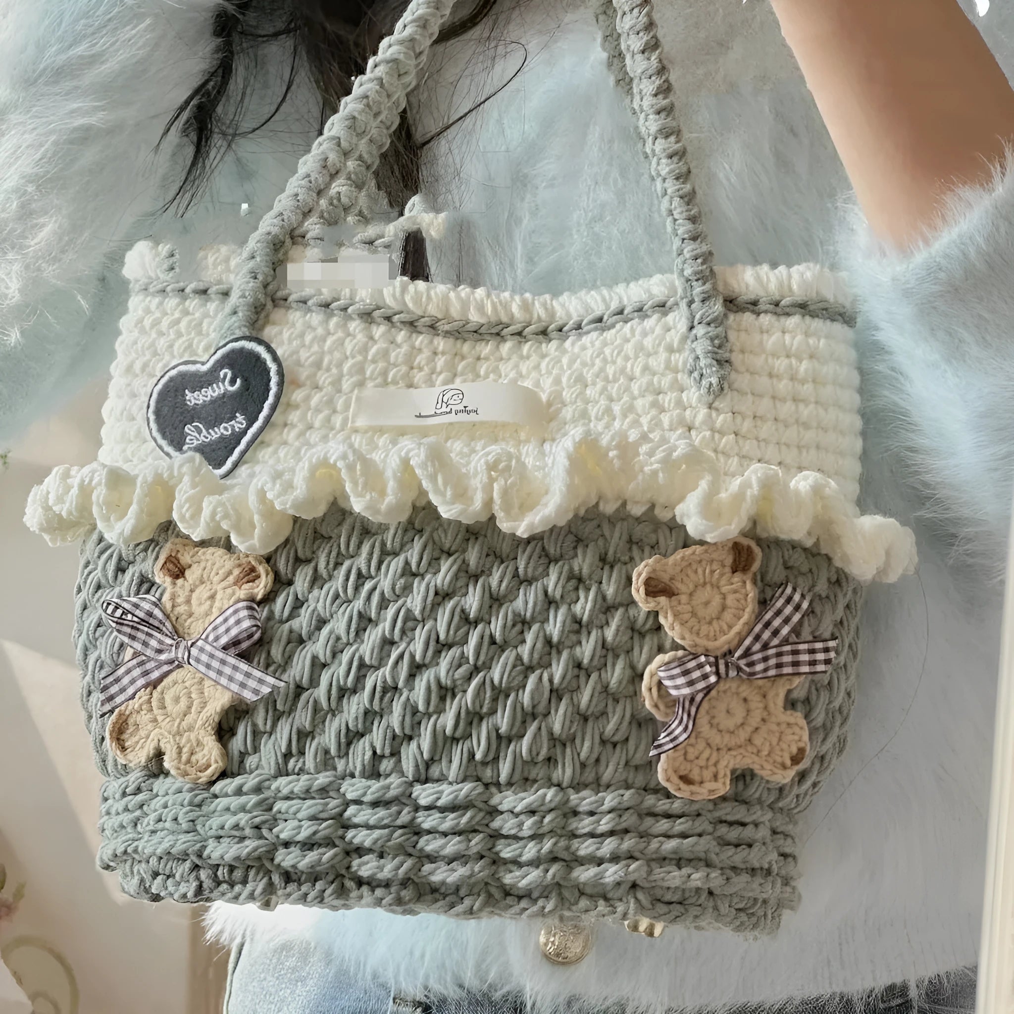 Wool crocheted bear-shaped shoulder bag with a wooden handle in a random colour pattern.