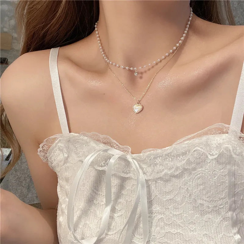 Gold-tone zinc alloy double-layer necklace with heart-shaped pendant and adjustable 21-50cm regular chain for women.