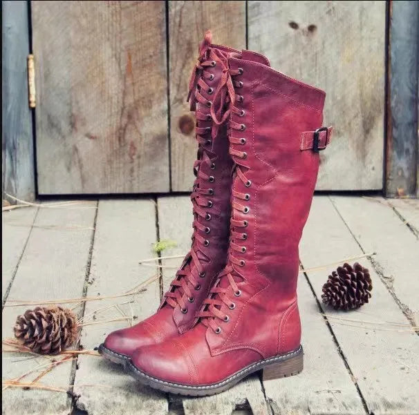 Black women's high leg boots with a low chunky heel and round toe made from artificial PU.