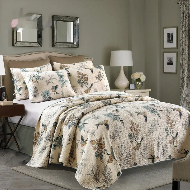 Quilted pure cotton bed cover and pillowcase set laid on a double bed, showing detailed printed pattern.
