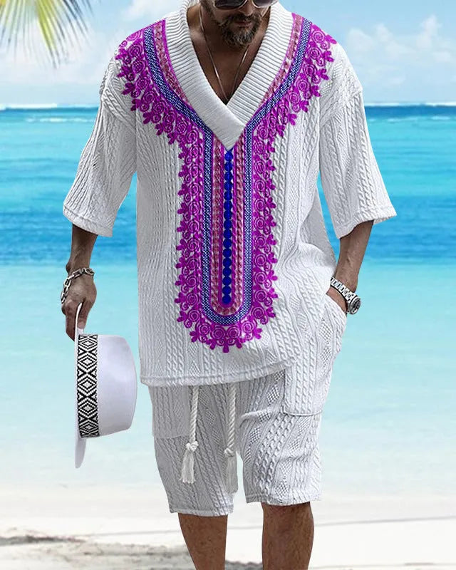 Man wearing a printed drop-shoulder knitted short-sleeve top and matching shorts in a casual setting.