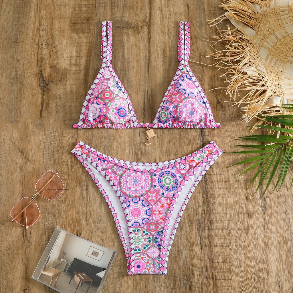 Women's retro-style printed swim bikini set in orange, pink, black, and blue colours on a mannequin.
