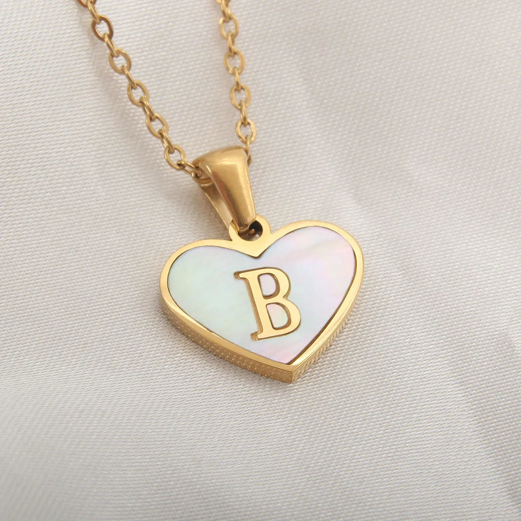 Gold plated heart-shaped white shell necklace with personalised text on a stainless steel chain.