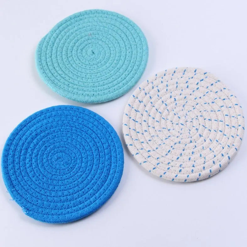 Three round cotton cord coasters in 18cm diameter showing grey, pink, purple and blue colour options