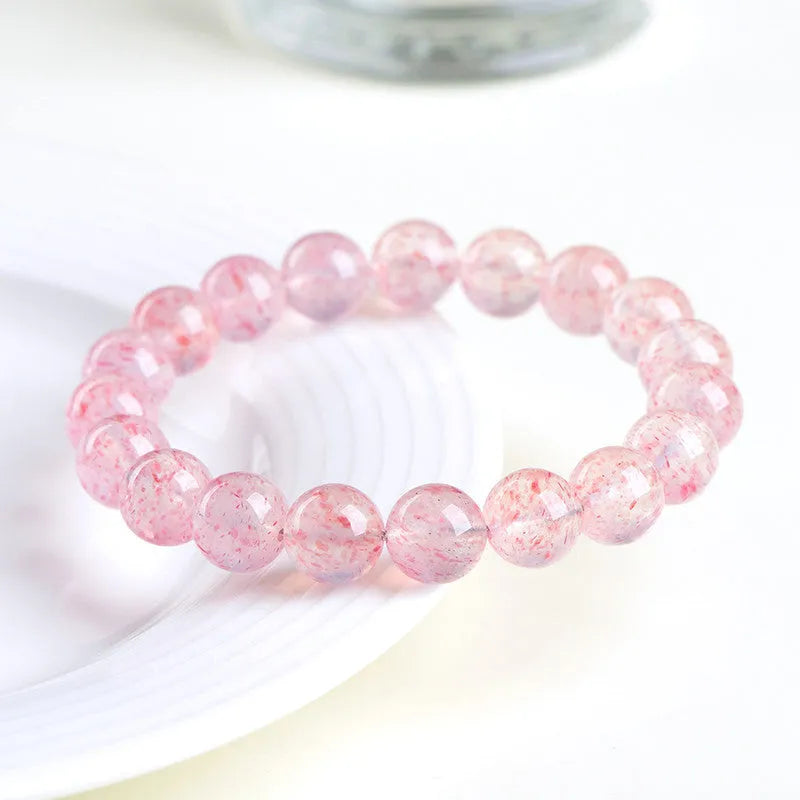 Geometric strawberry quartz crystal beads bracelet in natural white water colour on a wrist.