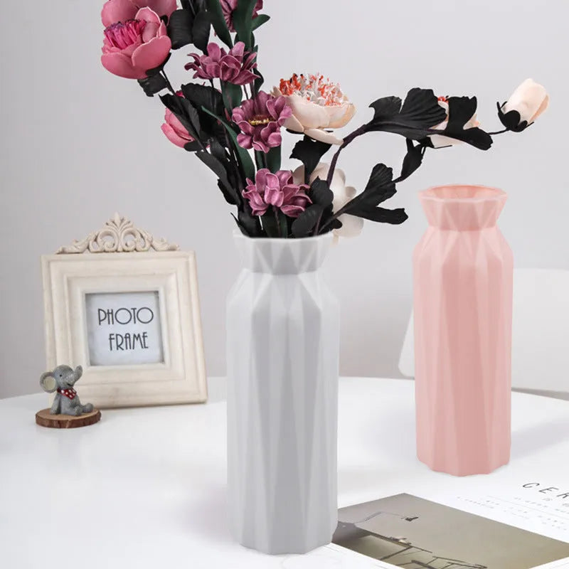 Green plastic melamine vase with a wide, stable base on a wooden surface.