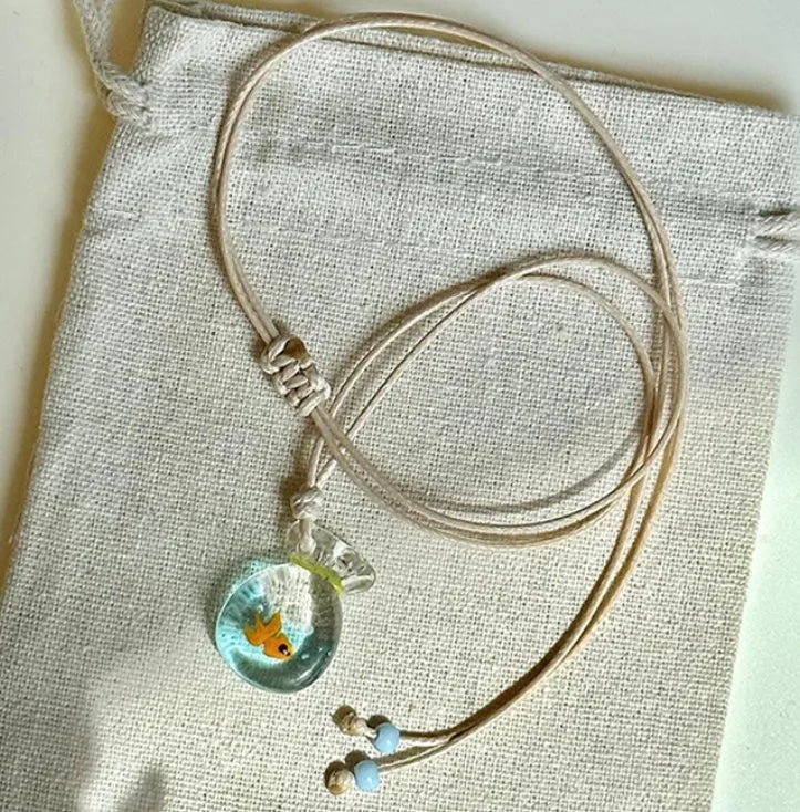 Women's joker pendant necklace on braided cotton linen cord with adjustable lobster clasp.