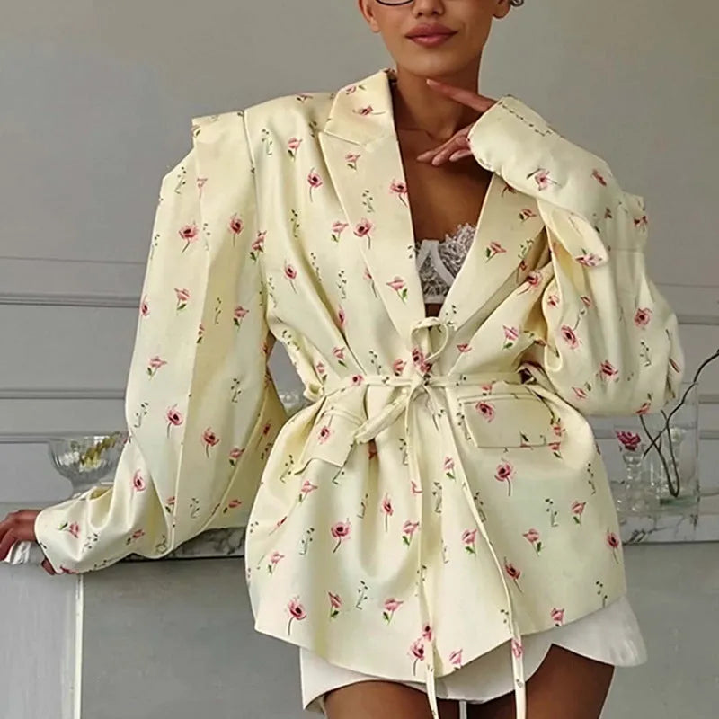 Women's white suit jacket with a lace-up detail on the collar and an adjustable waist tie, shown in a regular fit with long sleeves.