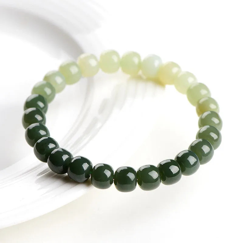 Natural Hetian jade bracelet with gradient clear water colour and polished beads.