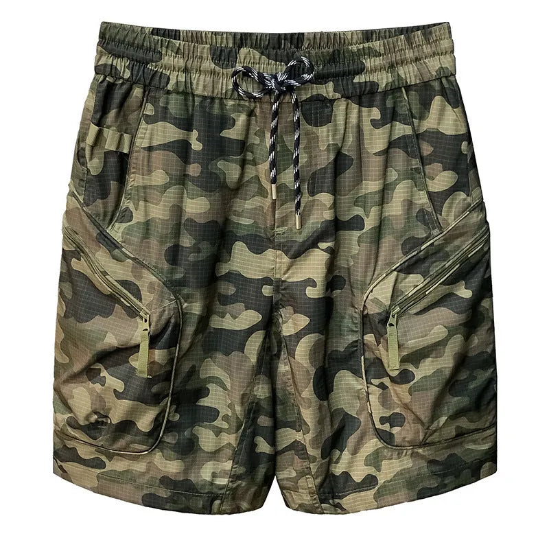 Man wearing olive camouflage cargo shorts with a loose fit and cargo pockets.